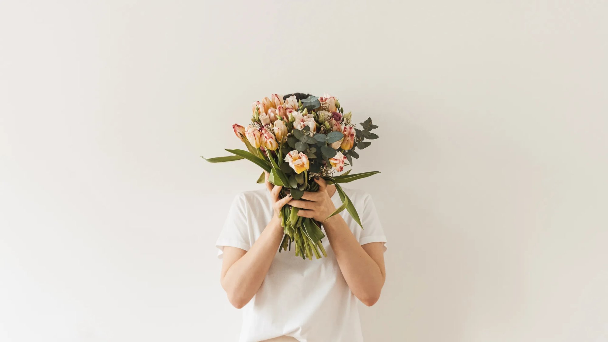 Person holding a lush spring bouquet — Full Bloom Counseling Denver therapists for anxiety, trauma, and healing